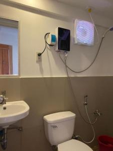 a bathroom with a toilet and a sink at Raje Residence El Nido in El Nido +18 photos