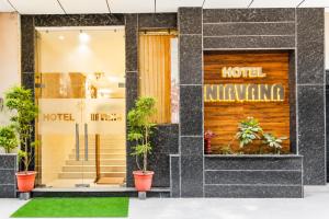a hotel lobby with plants in the window at The Nirvana Delhi Airport - FREE Airport Drop in New Delhi