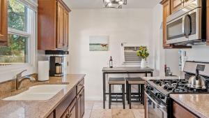 a kitchen with a sink and a stove at Hideaway on Oak by AvantStay in Paso Robles