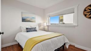 a white bedroom with a bed and a window at Hideaway on Oak by AvantStay in Paso Robles