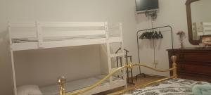 a white bunk bed in a room with a mirror at Affittacamere Casa Sermide in Caniparola di Fosdinovo