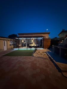 a house with a lawn in front of it at night at Casa Dutu in Tuzla +6 photos