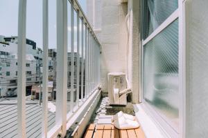 a balcony with a heater on the side of a building at Chic 1 Bedroom Space Near Nakasu in Fukuoka