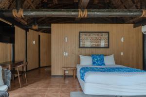 a bedroom with a bed and a table in a room at Le Lagoto Resort & Spa in Fagamalo +54 photos