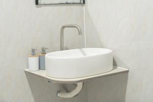 a bathroom with a white sink and a fosset at Faafu View Maldives in Maldive Islands