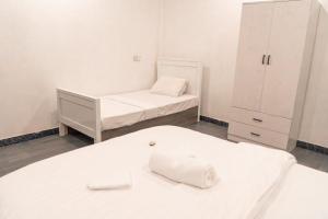 a small room with two beds and a dresser at Faafu View Maldives in Maldive Islands