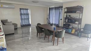 a living room with a dining room table and chairs at Beachfront House in Garapan