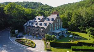 an aerial view of a large house in the mountains at Moulin de Daverdisse in Daverdisse