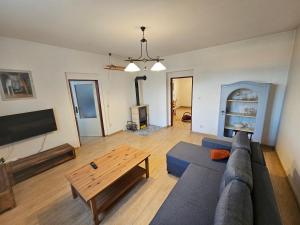 a living room with a couch and a coffee table at Apartment Nová Ves 26 in Olešník