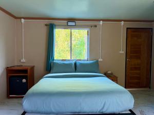 a large bed in a room with a window at Sweed Dee Love Hostel in Phi Phi Islands +51 photos