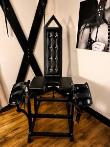 a black chair in a room with a picture at Casa Amor - Kinky Hotel UK in Southampton +27 photos