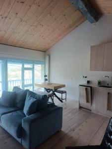 a living room with a blue couch and a table at Benaki 92B in Ladines