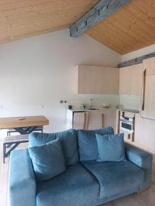 a blue couch in a living room with a kitchen at Benaki 92B in Ladines