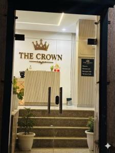 a store entrance with a crown sign on the wall at THE CROWN HOTEL & restaurants in Farrukhnagar