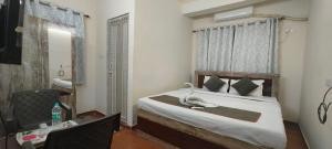 a bedroom with a bed with a stuffed animal on it at M A P Hotel in Nager Bazaar