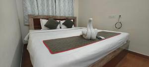a bed with a stuffed ostrich sitting on top of it at M A P Hotel in Nager Bazaar +2 photos
