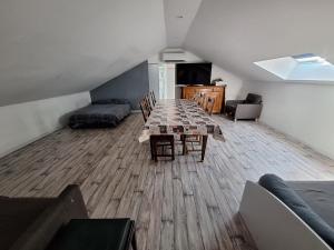 a living room with a table and a couch at Appartement Les 3 L in Vions