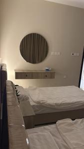 a bedroom with two beds and a mirror on the wall at شقة غرفتين وصالة مريحة in Jeddah
