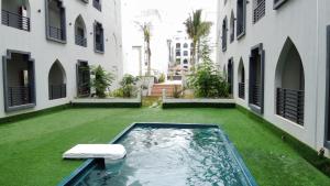 a swimming pool in the middle of a building at Rima Salalah in Salalah
