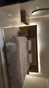a bedroom with a bed with white sheets and pillows at شقة غرفتين وصالة مريحة in Jeddah +3 photos