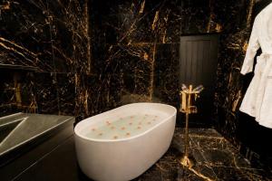 a bathroom with a bath tub and a sink at Casa Amor - Adult Only Retreat Midlands in Stoke on Trent