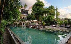 a swimming pool with lounge chairs and a hotel at Indochine Serenity Boutique in Siem Reap +101 photos