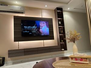 a flat screen tv on a wall in a living room at شقة غرفتين وصالة مريحة in Jeddah
