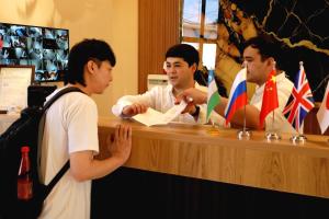 a group of men standing around a counter at National Gold Plaza in Samarkand +106 photos