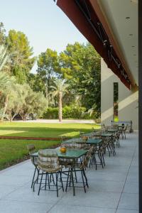 a row of tables and chairs on a patio at Palais Zaitunay in Marrakesh