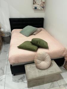 a bed with two pillows on it with a platform at Souad in Saint-Vallier +2 photos