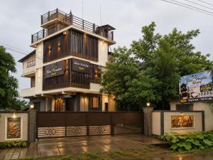 a building with a balcony on top of it at Bliss Paradise Resort in Malvan