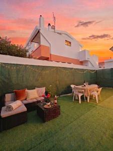 a backyard with a couch and a table and a tableablish at In DhomeU Tua - Free Wifi & Private Garden in Selargius