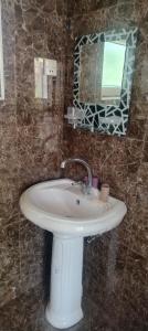 a bathroom with a white sink and a mirror at Ancient Lahij Guest House in Lahıc +27 photos