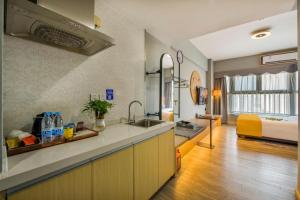 a kitchen with a sink and a living room at Yunting Resort in Huadu