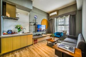 a living room with a couch and a table at Yunting Resort in Huadu