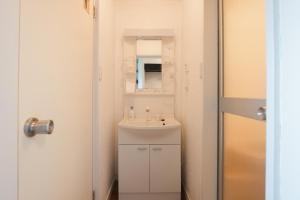 a small bathroom with a sink and a mirror at Numazu Royal Retreat 201 in Numazu +29 photos