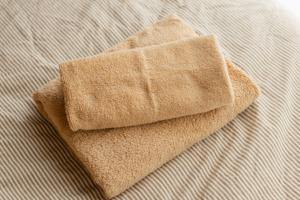 a close up of a towel on a bed at Numazu Royal Retreat 201 in Numazu