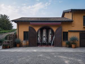 a building with a large doorway with a gate at Biondelli Boutique Winery in Cazzago San Martino