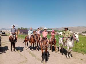 a group of people riding horses on a dirt road at Aalam ordo in Shabdan