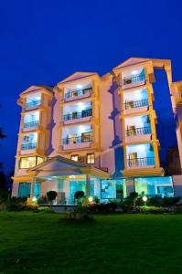a large building at night with its lights on at Hotel Colva Kinara in Colva