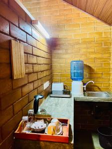 a kitchen with a sink and a brick wall at Lunuvila Resort Hiriketiya Dikwella in Dickwella +126 photos