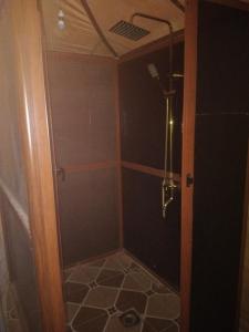 a shower with a glass door in a bathroom at Merzouga camelle trike bivoage in Merzouga