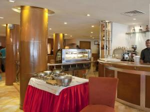 a kitchen with a table with pots and pans on it at Ohris Baseraa in Hyderabad +36 photos
