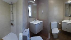 a bathroom with a toilet and a sink and a mirror at Lorca Express Suite in Lorca
