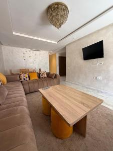 a living room with a couch and a wooden table at Blue water house in Tamaris