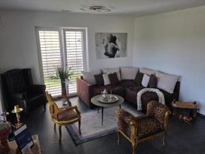 a living room with a couch and a table and chairs at V.I.P Appartement in Böttstein