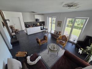 a living room with a couch and chairs and a table at V.I.P Appartement in Böttstein