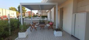a patio with chairs and tables on a building at Casa Soria in Pesaro