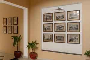 a wall with framed photos on a wall at Chez Lavania - A Boutique Stay in Udaipur
