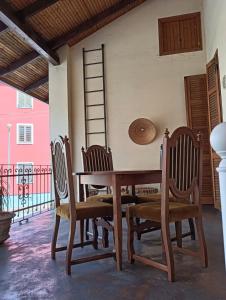 a dining room table with chairs and a ladder at Charm Studio - Large private terrace, Masserano in Masserano